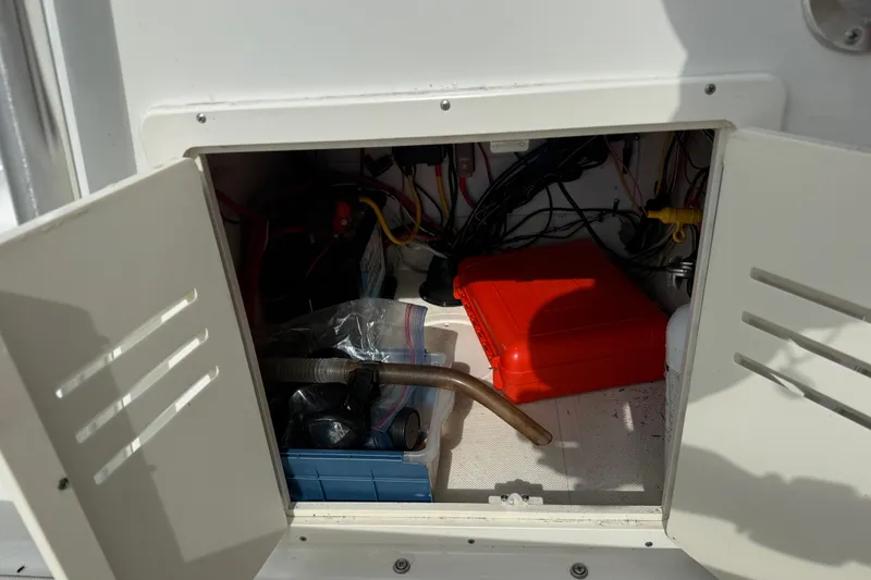 Slide: The Image of Open storage compartment on 2016 Panga 22 BOCA GRANDE boat with tools and equipment. - 27