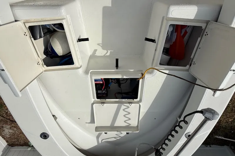 Slide: The Image of 2016 Panga 22 BOCA GRANDE boat storage compartments with open hatches and visible equipment. - 33