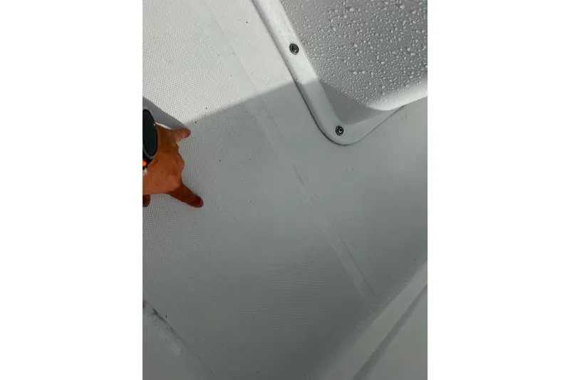 Slide: The Image of Close-up of a 2016 Panga 22 BOCA GRANDE boat deck with hand pointing. - 37