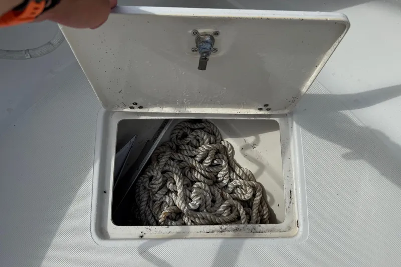 Slide: The Image of Open storage compartment on 2016 Panga 22 BOCA GRANDE boat with coiled rope inside. - 41