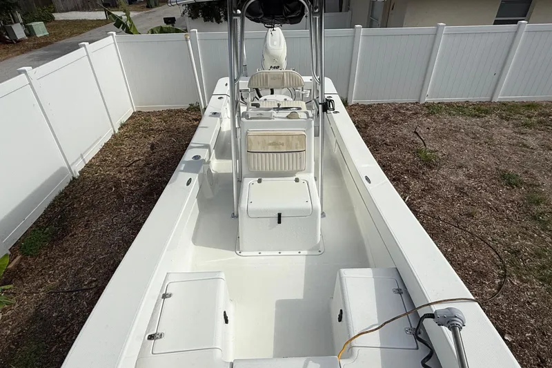 Slide: The Image of 2016 Panga 22 Boca Grande boat in a fenced yard, showcasing spacious deck layout. - 42