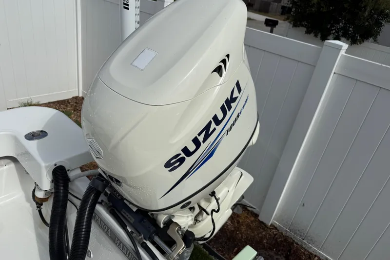 Slide: The Image of Suzuki outboard motor on 2016 Panga 22 Boca Grande boat, white fence background. - 43