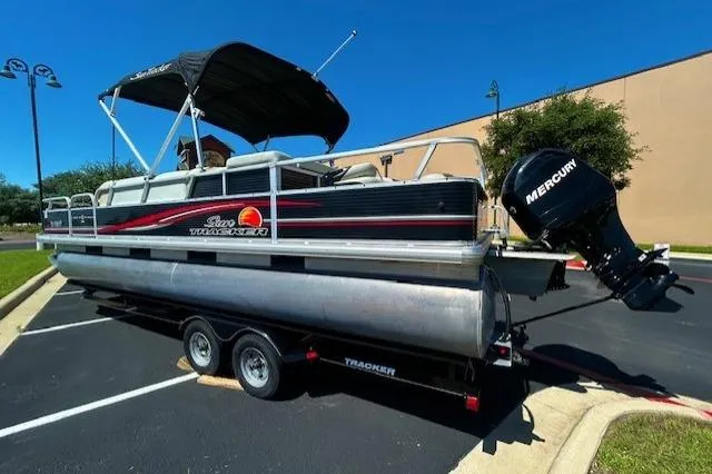 The Image of 2011 Sun Tracker Fishin' Barge 24 DLX pontoon boat with Mercury outboard motor on trailer. - 1