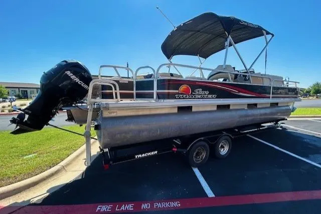 Slide: The Image of 2011 Sun Tracker Fishin' Barge 24 DLX pontoon boat on trailer in parking lot. - 3
