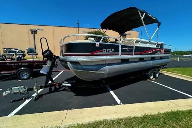 Slide: The Image of 2011 Sun Tracker Fishin' Barge 24 DLX pontoon boat on trailer in parking lot. - 4