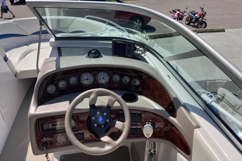 Slide: The Image of 2002 Four Winns 240 Horizon boat dashboard with steering wheel and instrument panel. - 6