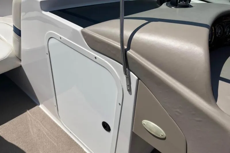 Slide: The Image of Interior view of a 2002 Four Winns 240 Horizon boat, showcasing dashboard and seating area. - 9