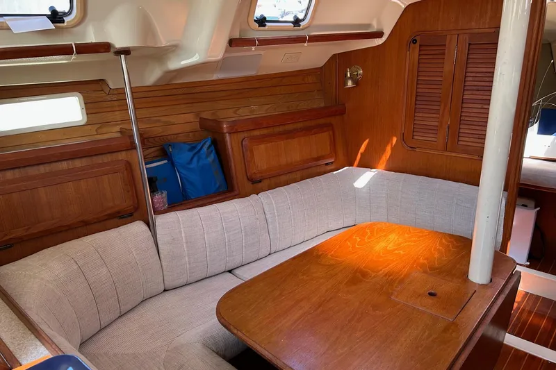 Slide: The Image of Cozy interior of 1991 Hunter Legend 375 sailboat with wooden table and cushioned seating. - 10