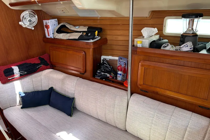 Slide: The Image of Interior of a 1991 Hunter Legend 375 sailboat with cozy seating and wooden cabinetry. - 11