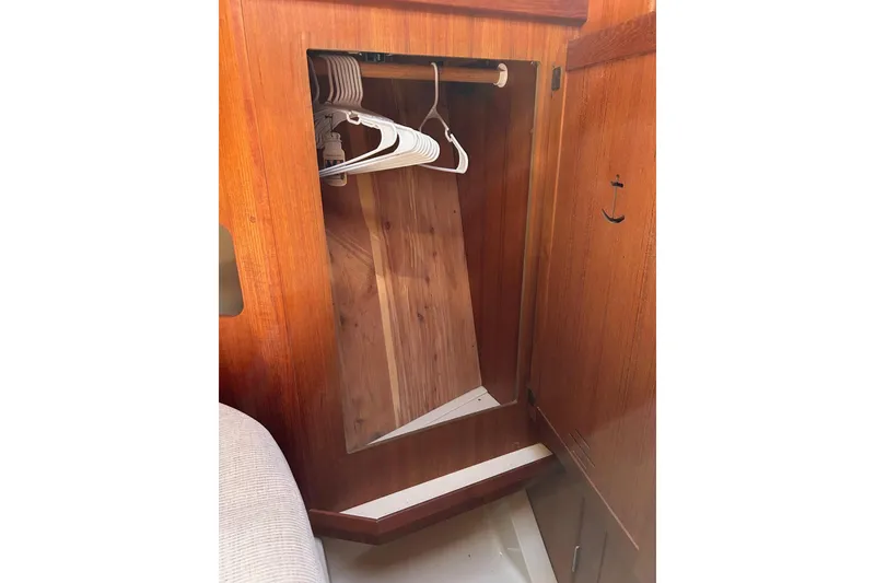 Slide: The Image of Wooden closet interior with hangers on a 1991 Hunter Legend 375 sailboat. - 12