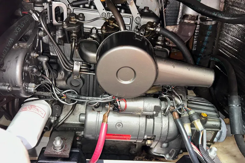 Slide: The Image of Engine of a 1991 Hunter Legend 375 sailboat, showcasing intricate mechanical components. - 14