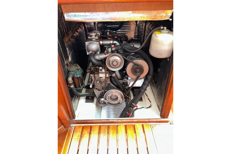Slide: The Image of Engine compartment of a 1991 Hunter Legend 375 sailboat, showcasing mechanical components. - 16