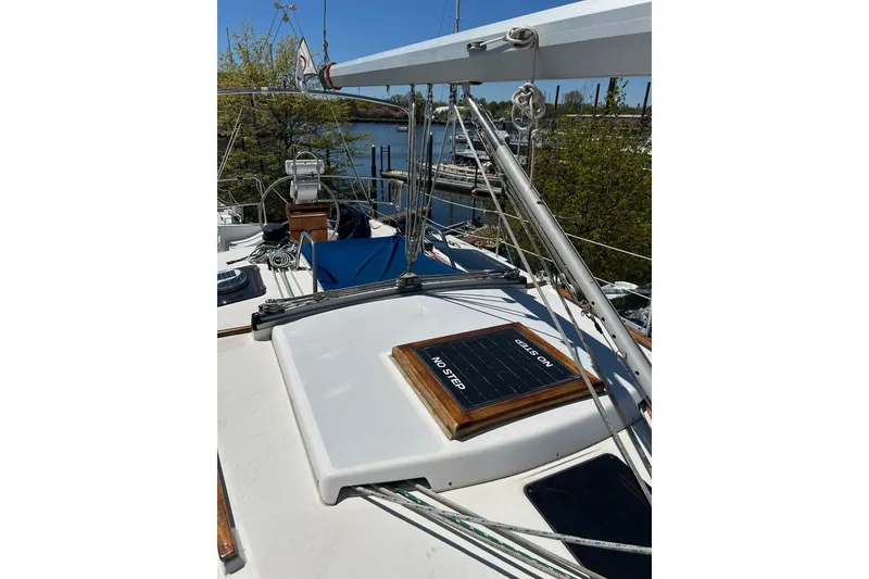 Slide: The Image of 1991 Hunter Legend 375 sailboat deck with rigging and "No Step" sign. - 2