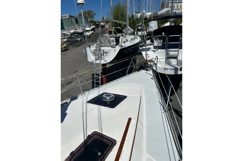 Slide: The Image of Sailboats docked at a marina, featuring a 1991 Hunter Legend 375. - 3