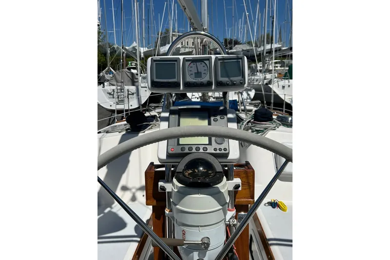 Slide: The Image of Cockpit view of 1991 Hunter Legend 375 sailboat with navigation instruments and steering wheel. - 6