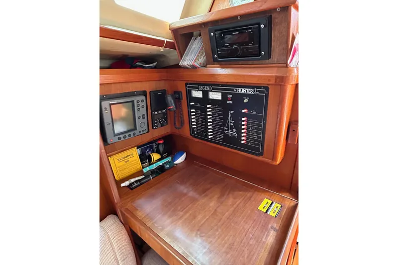 Slide: The Image of Navigation station of 1991 Hunter Legend 375 sailboat with control panel and equipment. - 7