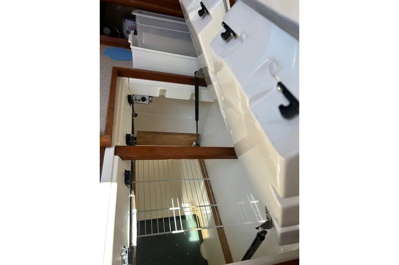 Slide: The Image of Interior storage compartments of a 1991 Hunter Legend 375 sailboat, featuring organized shelving. - 9