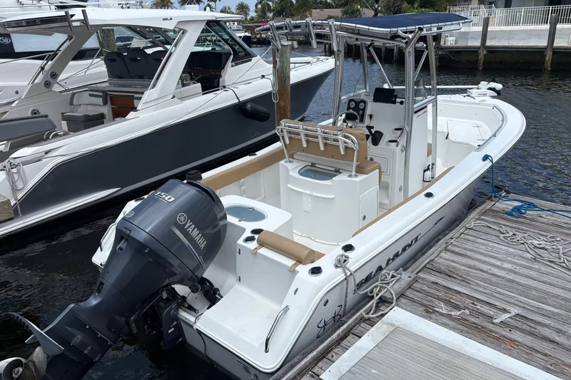 Slide: The Image of 2013 Seahunt Triton 225 boat interior with tan seating and storage compartments. - 10