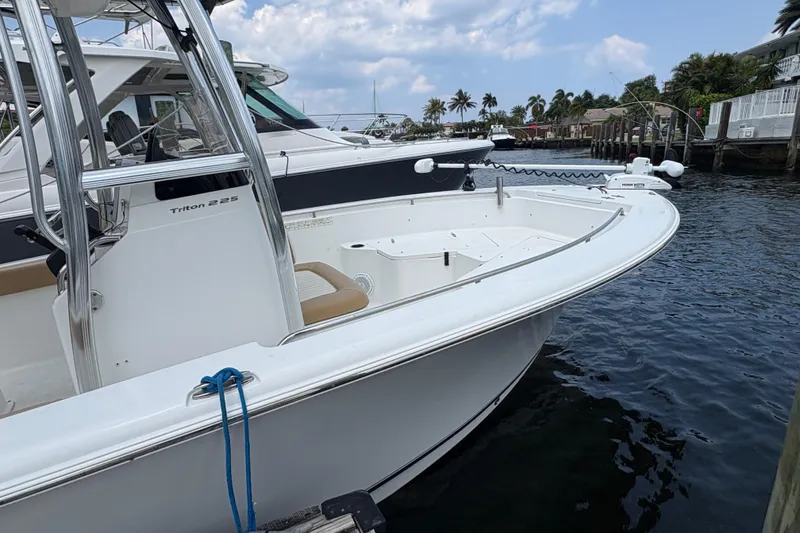 Slide: The Image of 2013 Seahunt Triton 225 boat interior with helm, seating, and control panel. - 11