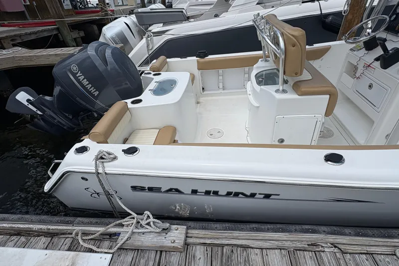 Slide: The Image of 2013 Seahunt Triton 225 boat with outboard motor and seating area. - 13