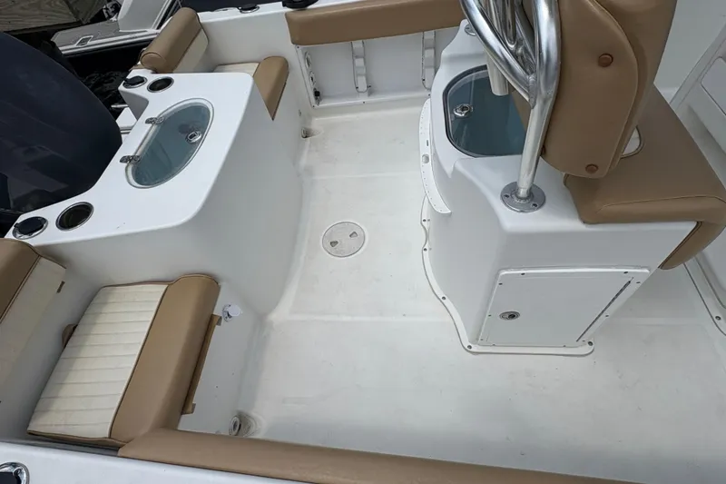 Slide: The Image of Outboard motor on a 2013 Seahunt Triton 225 boat, docked by the water. - 14