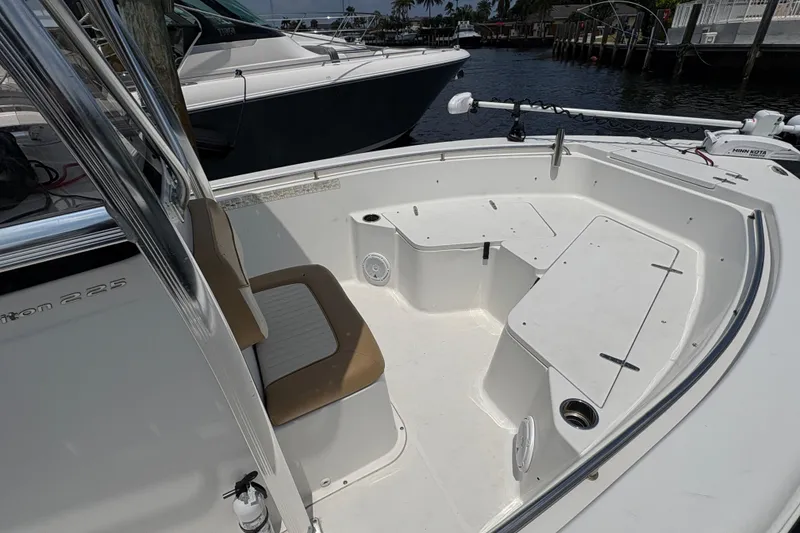 Slide: The Image of 2013 Seahunt Triton 225 boat interior with seating and storage compartments. - 16