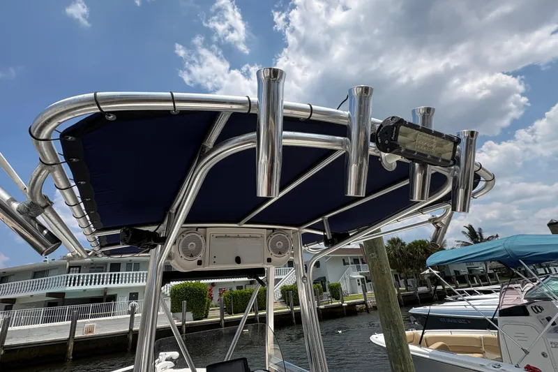 Slide: The Image of 2013 Seahunt Triton 225 boat docked, featuring a center console and seating area. - 21