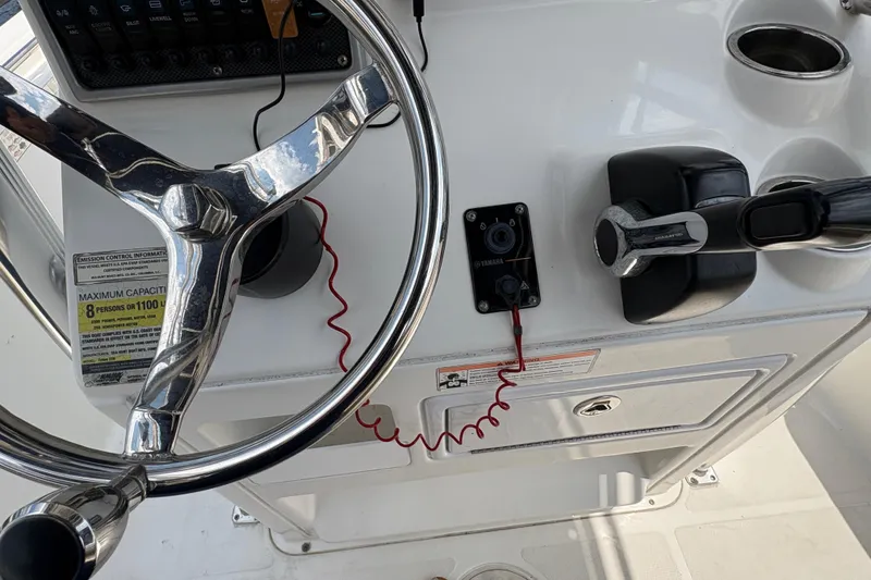 Slide: The Image of Open storage compartment on 2013 Seahunt Triton 225 boat with rope and equipment inside. - 24