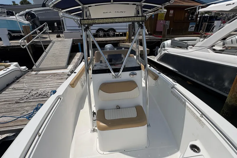 Slide: The Image of Open storage compartment on a 2013 Seahunt Triton 225 boat, showing interior details. - 25