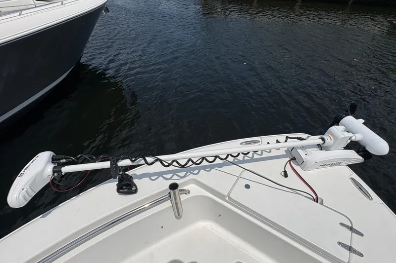 Slide: The Image of LED light mounted on a 2013 Seahunt Triton 225 boat's canopy frame at a marina. - 27