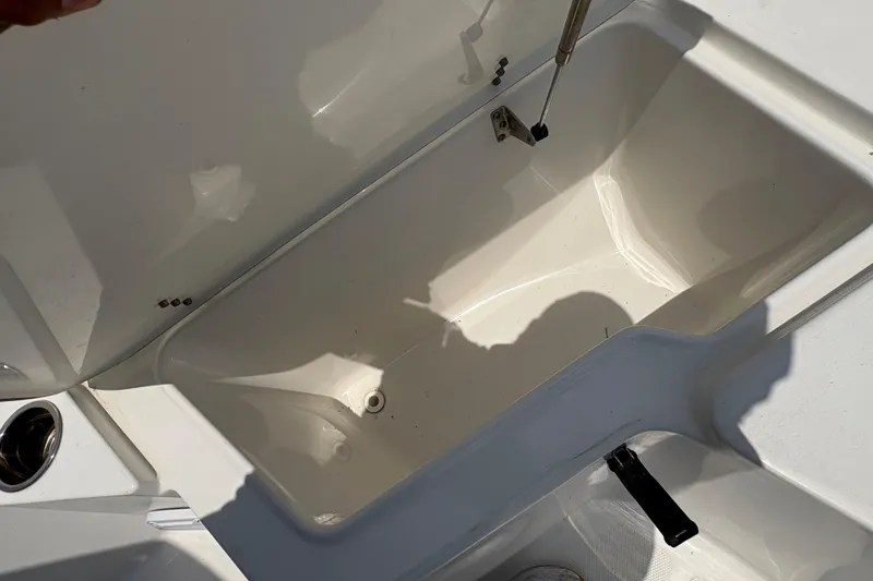 Slide: The Image of 2013 Seahunt Triton 225 boat docked, featuring Yamaha outboard motor, under a partly cloudy sky. - 29