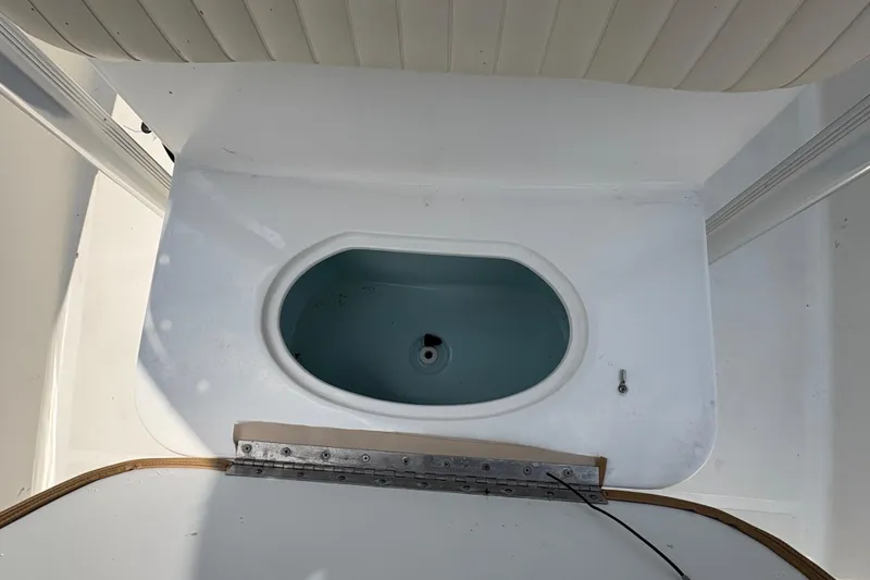 Slide: The Image of Storage compartment of a 2013 Seahunt Triton 225 boat with rope and equipment. - 30