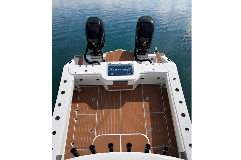 Slide: The Image of Freeman 34VH 2019 boat deck with twin engines on calm water. - 1