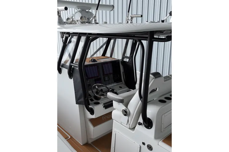 Slide: The Image of Interior view of a 2019 Freeman 34VH boat cockpit with advanced navigation controls. - 10