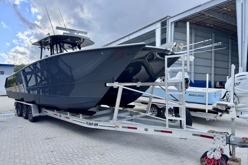 Slide: The Image of 2019 Freeman 34VH boat on trailer outside storage facility. - 13