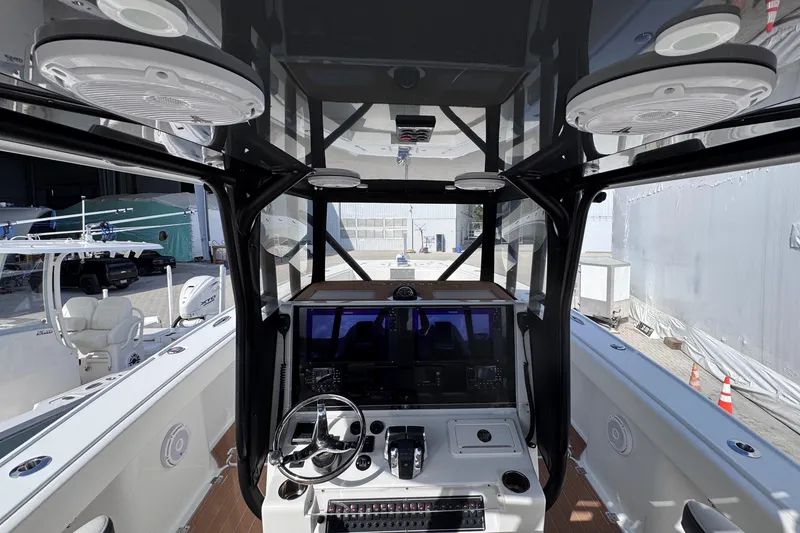 Slide: The Image of Interior view of a 2019 Freeman 34VH boat cockpit with modern controls and steering wheel. - 6
