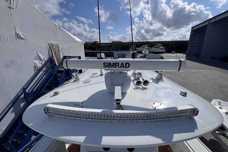 Slide: The Image of 2019 Freeman 34VH boat with Simrad radar, docked under a partly cloudy sky. - 8