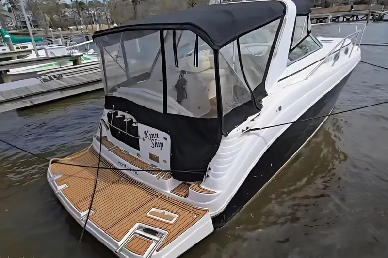 The Image of 2003 Rinker Fiesta Vee 342 boat docked at marina with covered cockpit. - 1