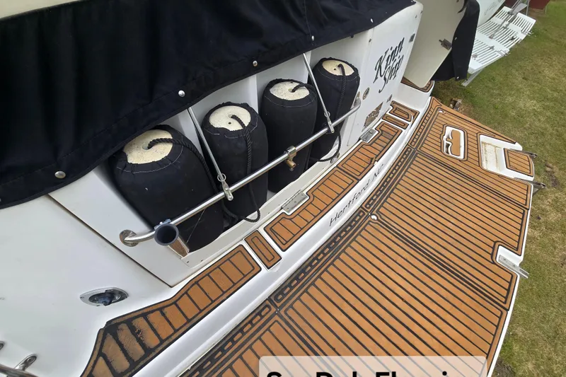 Slide: The Image of 2003 Rinker Fiesta Vee 342 boat with teak-style swim platform and fender storage. - 11