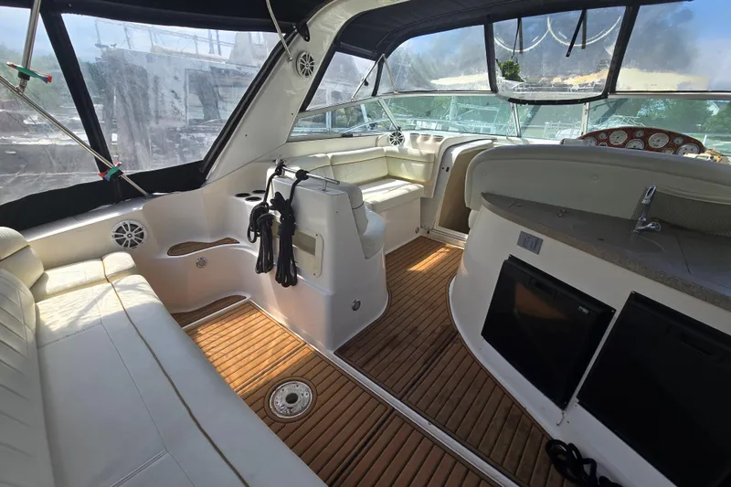 Slide: The Image of 2003 Rinker Fiesta Vee 342 boat interior with wood flooring and white seating. - 17