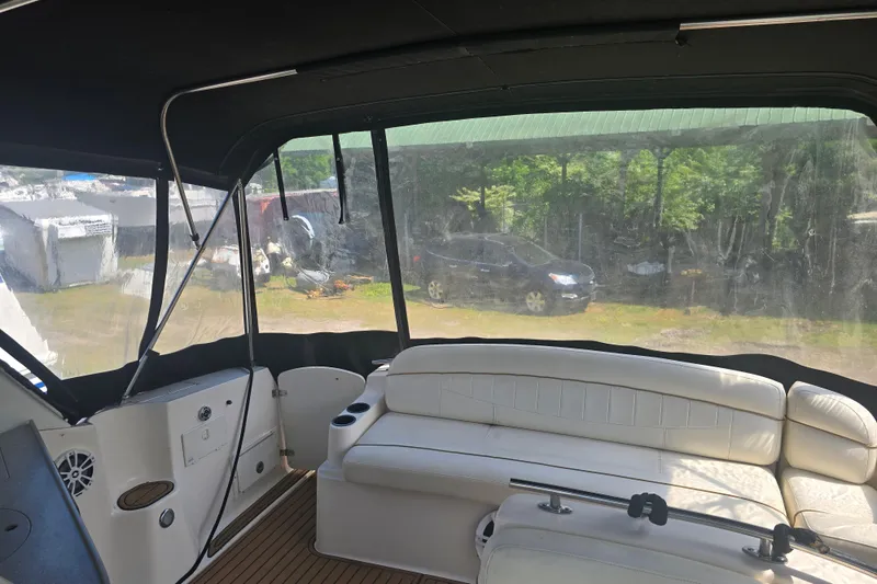Slide: The Image of Interior view of 2003 Rinker Fiesta Vee 342 boat with white seating and covered deck. - 18