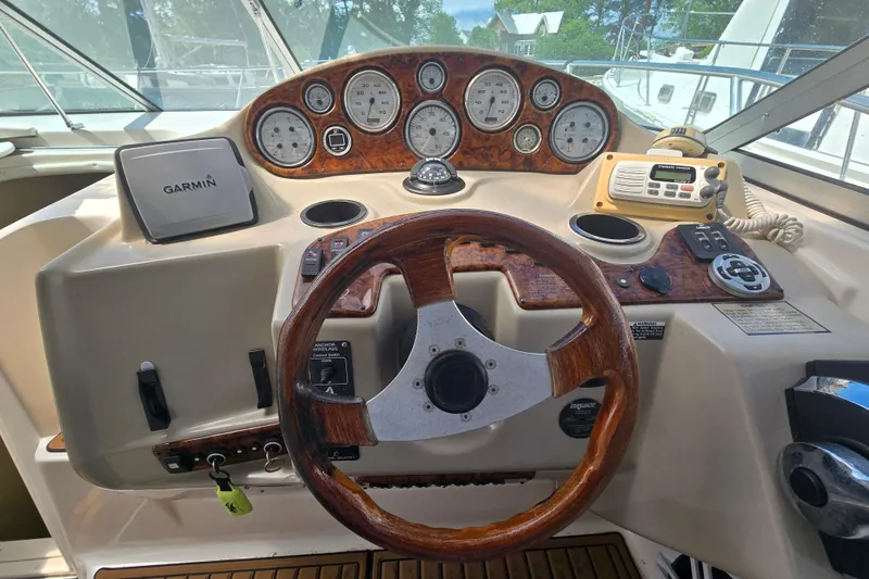 Slide: The Image of 2003 Rinker Fiesta Vee 342 boat dashboard with Garmin GPS and wood-accented steering wheel. - 21