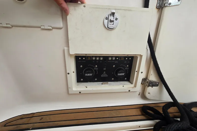 Slide: The Image of Control panel on a 2003 Rinker Fiesta Vee 342 boat, featuring dials and switches. - 22
