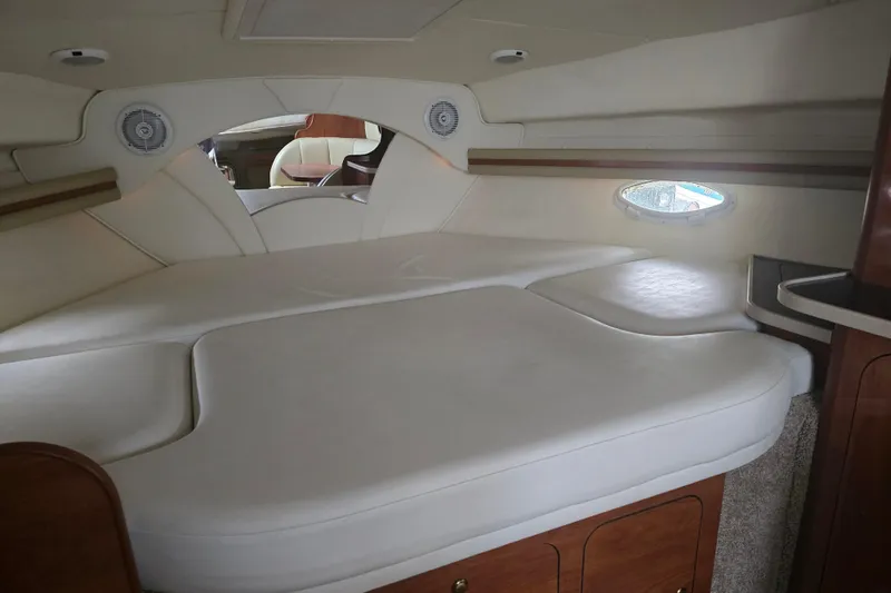 Slide: The Image of Interior cabin of 2003 Rinker Fiesta Vee 342 with cushioned seating and wood accents. - 26