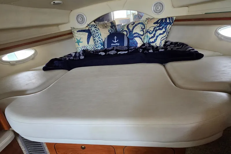 Slide: The Image of Interior cabin of 2003 Rinker Fiesta Vee 342 with nautical-themed bedding and cushions. - 27