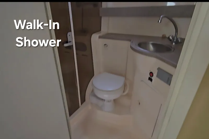 Slide: The Image of 2003 Rinker Fiesta Vee 342 bathroom with walk-in shower, toilet, and sink. - 28