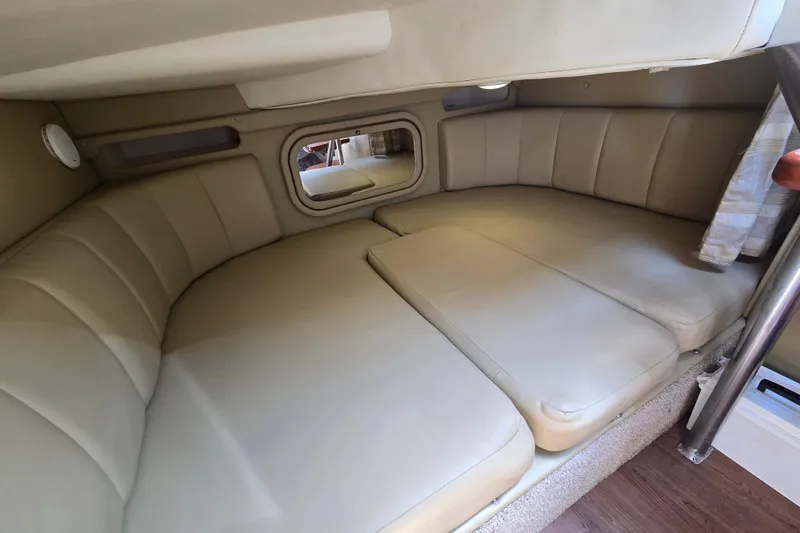 Slide: The Image of 2003 Rinker Fiesta Vee 342 cabin interior with beige seating and compact design. - 29