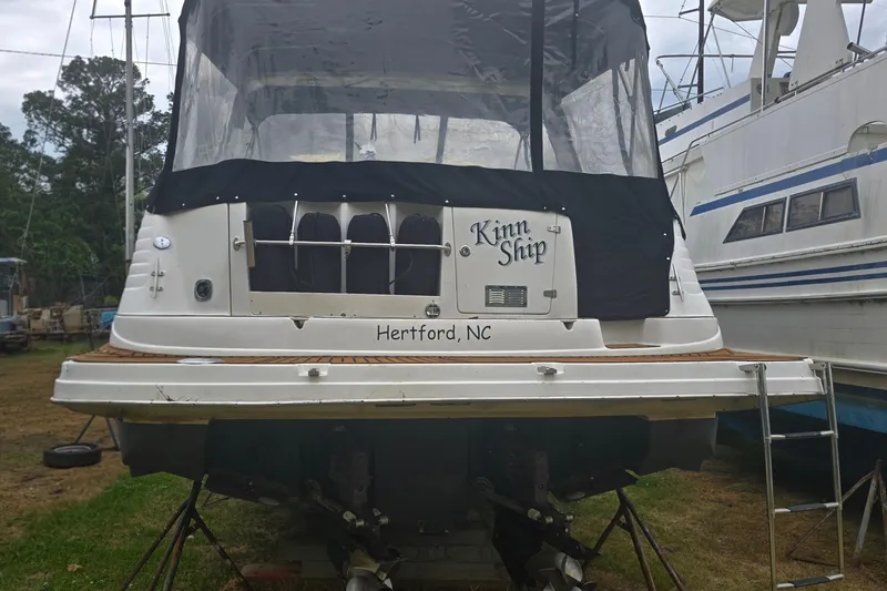Slide: The Image of 2003 Rinker Fiesta Vee 342 boat docked, rear view, named "Kinn Ship," Hertford, NC. - 3