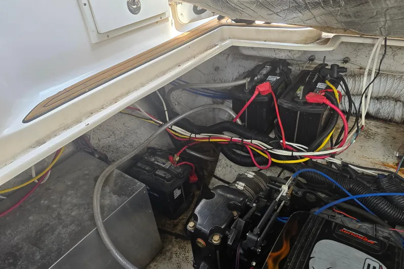 Slide: The Image of Engine compartment of a 2003 Rinker Fiesta Vee 342 with visible batteries and wiring. - 8