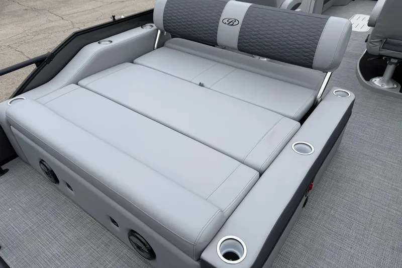 Slide: The Image of 2026 Bentley Pontoons Elite 253 Swingback with luxurious gray seating and cup holders. - 13